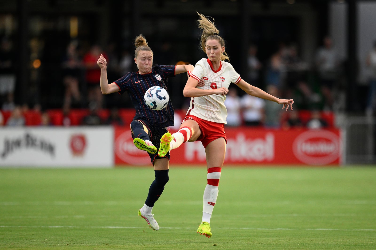 United States defender Emily Sonnett, left, and Canada forward Jordyn Huitema (9) battle for the ball during the first half of an international friendly soccer match, Wednesday, July 2, 2025, in Washington. (AP Photo/Nick Wass)