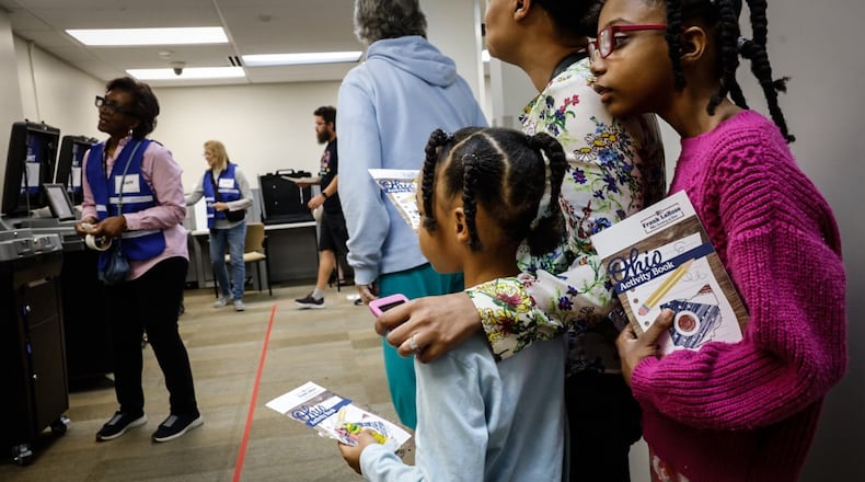 Keesha Melton along with her daughters Hannah and Kristiana stand in line to vote early at the Montgomery County Board of Elections Tuesday October 8, 2024. Jim Noelker/Staff