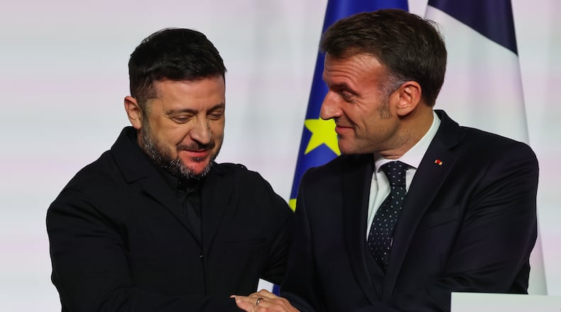 French President Emmanuel Macron, right, shakes hands to Ukraine's President Volodymyr Zelenskyy after the signing of the declaration on deploying post-ceasefire force in Ukraine during the 'Coalition of the Willing' summit on security guarantees for Ukraine, at the Elysee Palace in Paris Tuesday, Jan 6, 2026. (Ludovic Marin, Pool photo via AP)