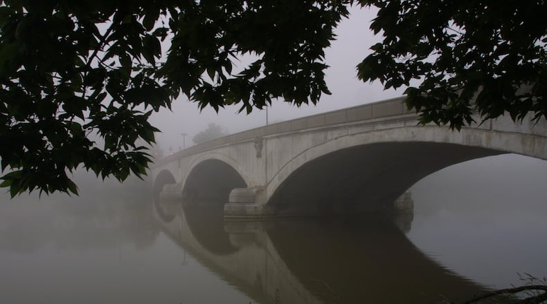 Wednesday morning fog shrouds the Helena Street bridge over the Great Miami River.