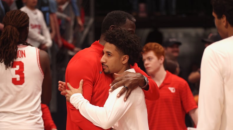 Dayton's Anthony Grant, left, and Javon Bennett hug after a loss to Illinois State in the first round of the National Invitation Tournament on Wednesday, March 25, 2026, at UD Arena in the quarterfinals of the National Invitation Tournament.. David Jablonski/Staff