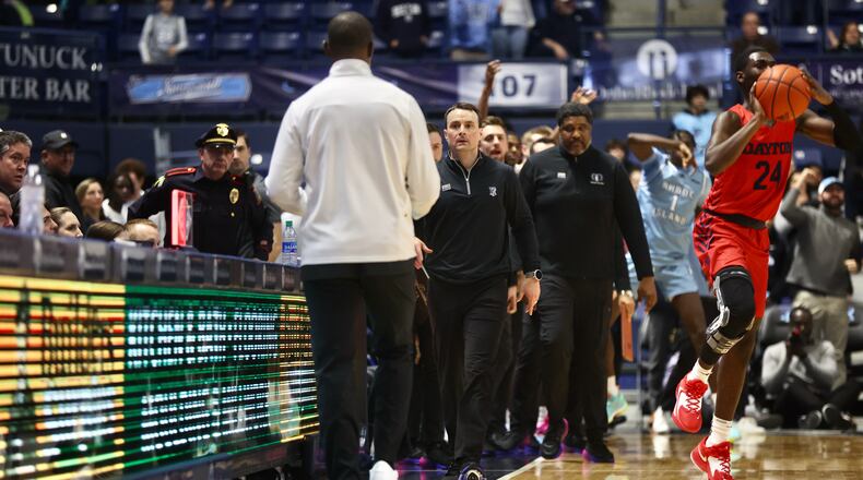 Rhode Island's Archie Miller walks to shake hands with Dayton's Anthony Grant after the game on Wednesday, Jan. 25, 2023, at the Ryan Center in Kingston, R.I. David Jablonski/Staff
