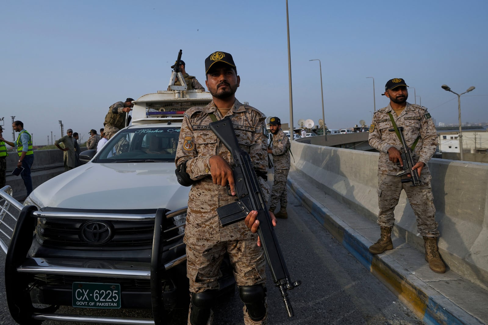 A paramilitary soldier stand alert on a road near Karachi port following raising military tension between Pakistan and India, in Karachi, Pakistan, Friday, May 9, 2025. (AP Photo/Fareed Khan)