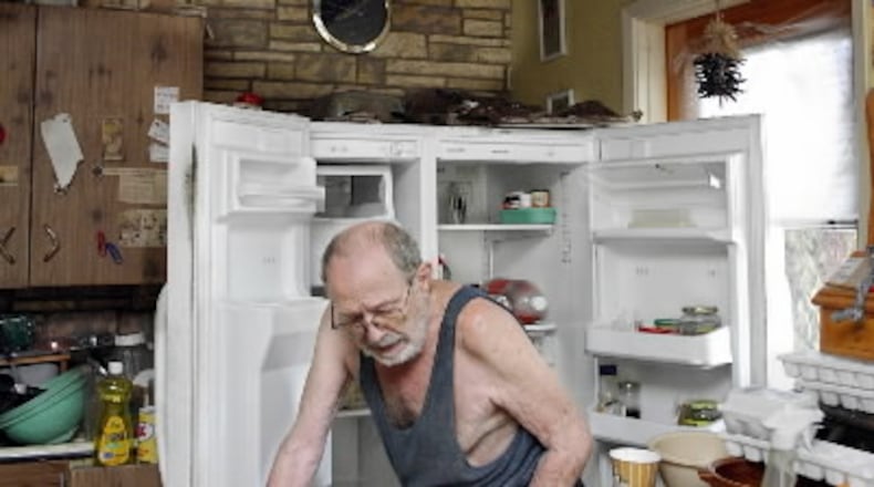 Vincent Sparaco, 86, of Lake Worth cleans out his refrigerator following Hurricane Frances in 2004. (Greg Lovett / The Post)