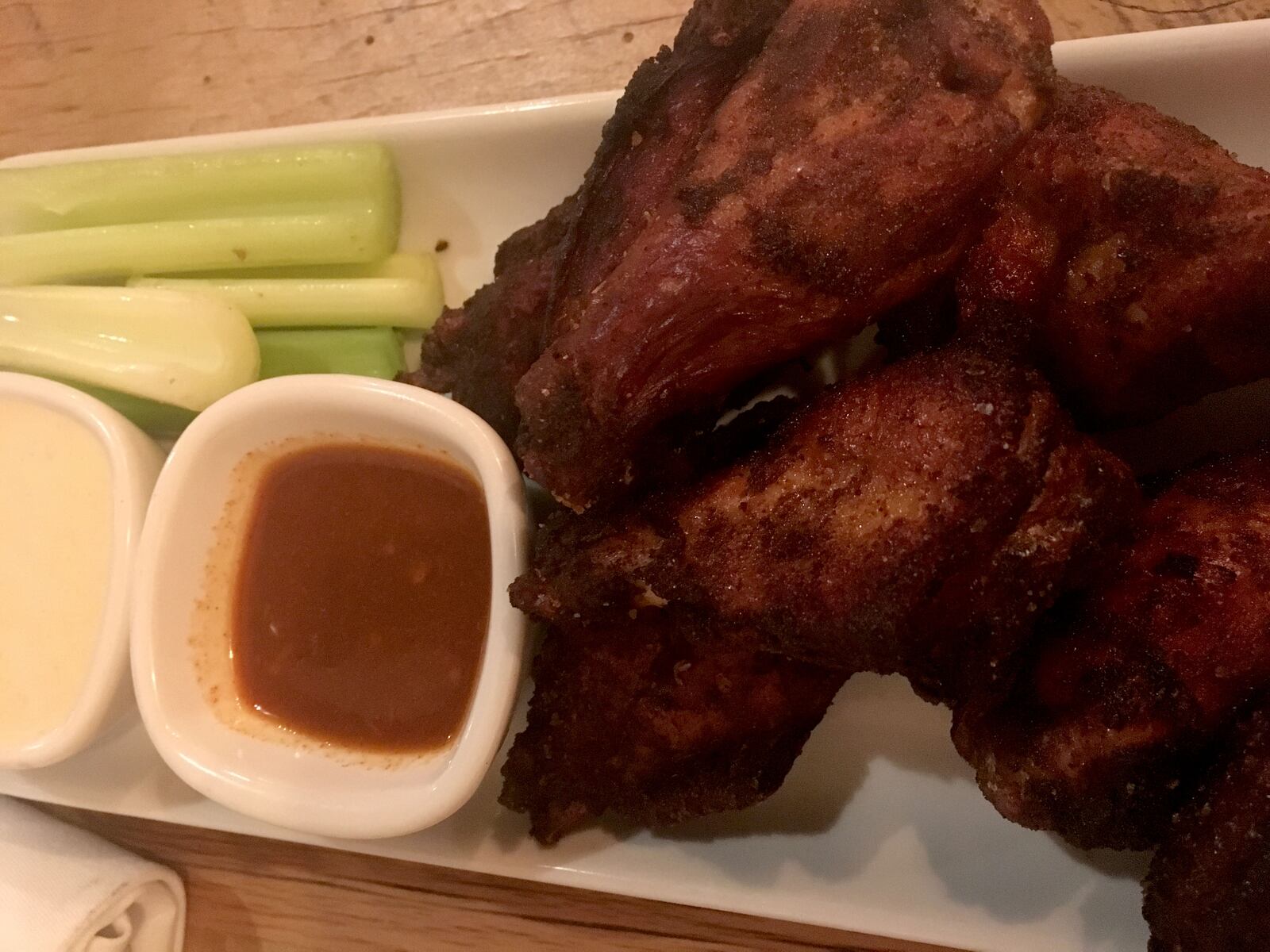 The food at Lock 27 in downtown Dayton. Pictured: smoked chicken wings with a sriracha blue cheese and a hot sauce.  Photo by Amelia Robinson