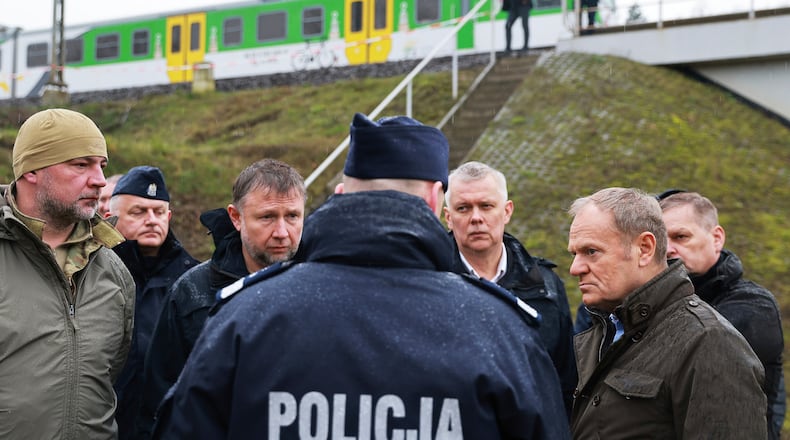 Prime Minister Donald Tusk, second right, visits site of the rail line Mika, that was damaged by sabotage, near Deblin, Poland, Monday, Nov. 17, 2025. (AP Photo/KPRM)