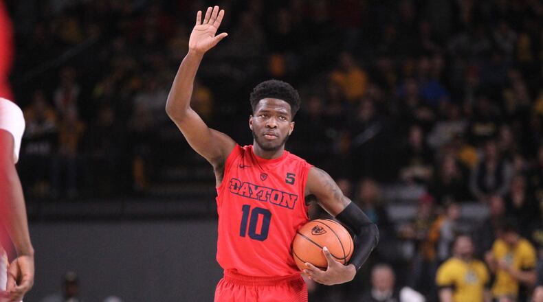 Dayton’s Jalen Crutcher runs the offense against Virginia Commonwealth on Saturday, Feb. 10, 2018, at the Siegel Center in Richmond, Va. David Jablonski/Staff