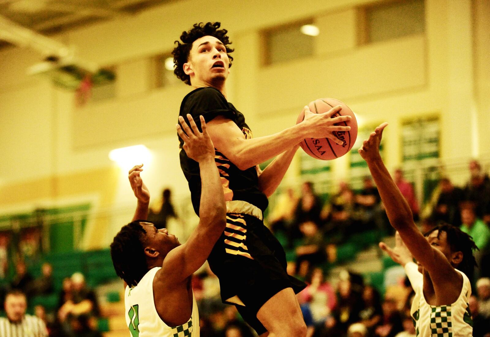 Sidney’s Andre Gordon (with ball) splits a pair of Northmont defenders. Sidney defeated host Northmont 72-68 in a boys high school basketball game on Tuesday, Jan. 15, 2019. GREG BILLING / CONTRIBUTED