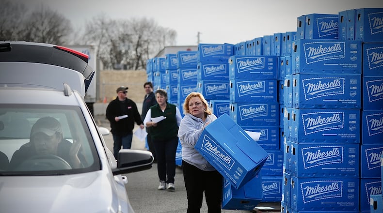 People waiting in line for over an hour to get their last chance to buy Mikesells potato chips at their facility on Leo Street Thursday morning March 2, 2023. MARSHALL GORBY \STAFF
