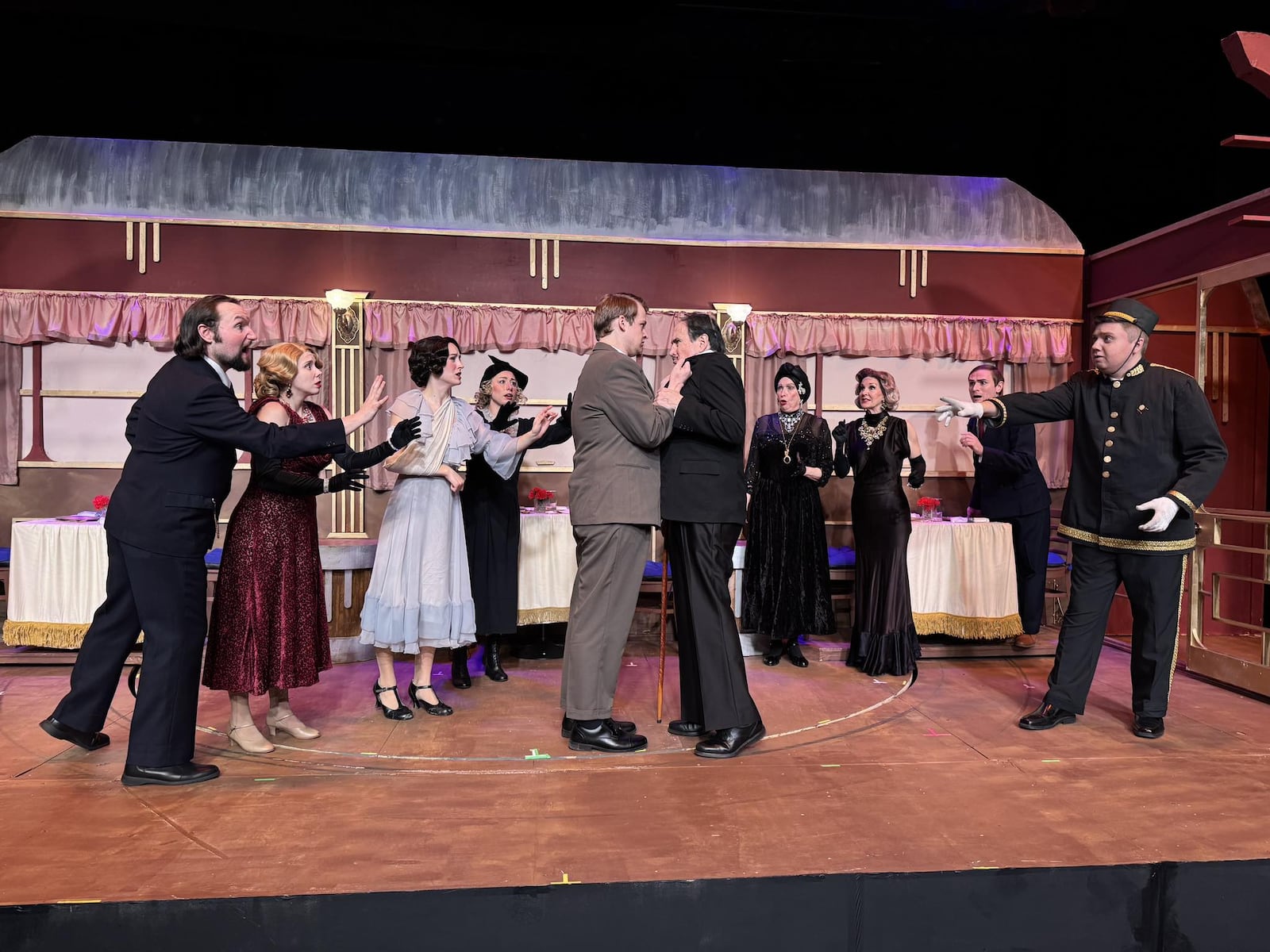 Left to right: Jacob Herr (Constantine Bouc), Meghan Slowik (Countess Andrenyi), LIly Walton (Mary Debenham), Hayley Martin (Greta Ohlsson), Ty Smith (Colonel Arbuthnot), David Shough (Hercule Poirot), Becky Saunders (Princess Dragomiroff), Karie-Lee Sutherland (Helen Hubbard), Jonathan Pendergrass (Hector MacQueen) and Jordan Wolfe (Michel/Waiter) in La Comedia Dinner Theatre's production of "Murder on the Orient Express." Photo by Justin Walton