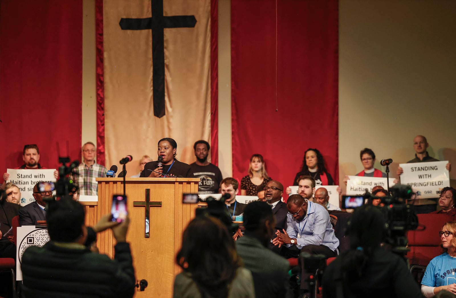 Geurline Jozef, founder of the Haitian Bridge Alliance, speaks during Here We Stand: Faith Leaders for Immigration Justice & Family Unity at St. John Missionary Baptist Church on Monday, Feb. 2, 2026, in Springfield. Pastors and community members gathered to pray and call for the extension of Temporary Protected Status which is scheduled to expire on Tuesday, Feb. 3, 2026. JOSEPH COOKE/STAFF