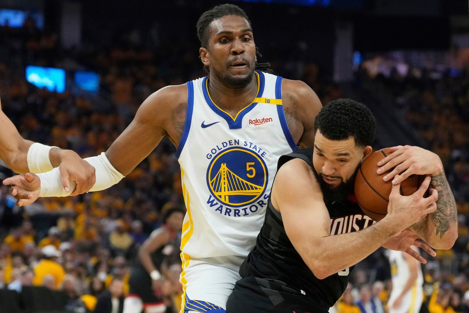Houston Rockets guard Fred VanVleet, bottom, grabs a rebound under Golden State Warriors forward Kevon Looney during the first half of Game 3 of an NBA basketball first-round playoff series in San Francisco, Saturday, April 26, 2025. (AP Photo/Jeff Chiu)