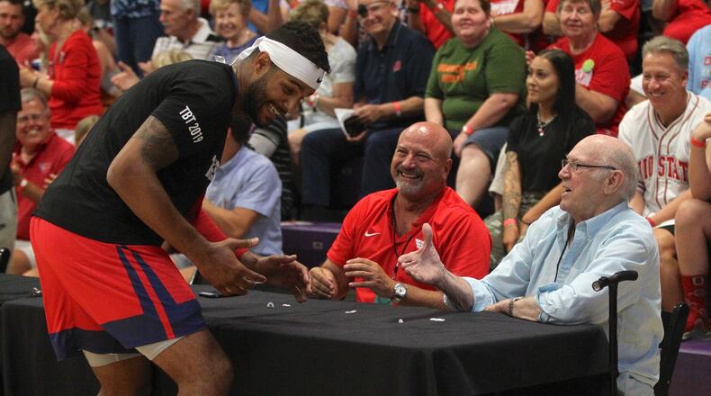 Devin Oliver, of the Red Scare, greets WHIO Radio’s Larry Hansgen and Bucky Bockhorn before the first-round game in The Basketball Tournament on Friday, July 19, 2019, at Capital University in Bexley. David Jablonski/Staff