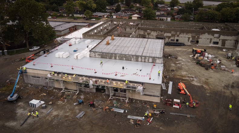Crews work on the new West Carrollton Early Childhood Center on 510 E. Pease Ave. JIM NOELKER/STAFF
