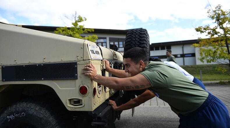 Airmen assigned to the 86th Airlift Wing push a Humvee during the annual Commander’s Challenge resiliency day at Ramstein Air Base, Germany, Sept. 6, 2017. Air Force Instruction 90-506 requires Air Force units to conduct two resiliency days each year. Wright-Patterson Air Force Base will hold a Wingman Day focused on resiliency May 10. (U.S. Air Force photo/Airman 1st Class Joshua Magbanua)