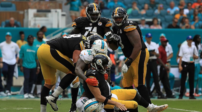 MIAMI GARDENS, FL - OCTOBER 16: Ben Roethlisberger #7 of the Pittsburgh Steelers is tackled after a pass by Andre Branch #50 and Cameron Wake #91 of the Miami Dolphins during a game on October 16, 2016 in Miami Gardens, Florida. (Photo by Mike Ehrmann/Getty Images)