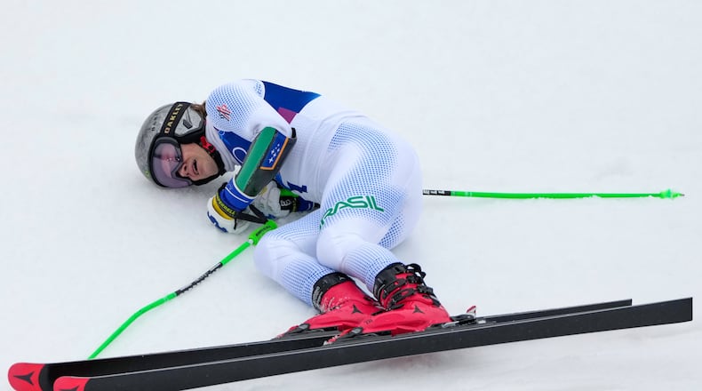 Brazil's Lucas Pinheiro Braathen celebrates winning an alpine ski, men's giant slalom race, at the 2026 Winter Olympics, in Bormio, Italy, Saturday, Feb. 14, 2026. (AP Photo/John Locher)