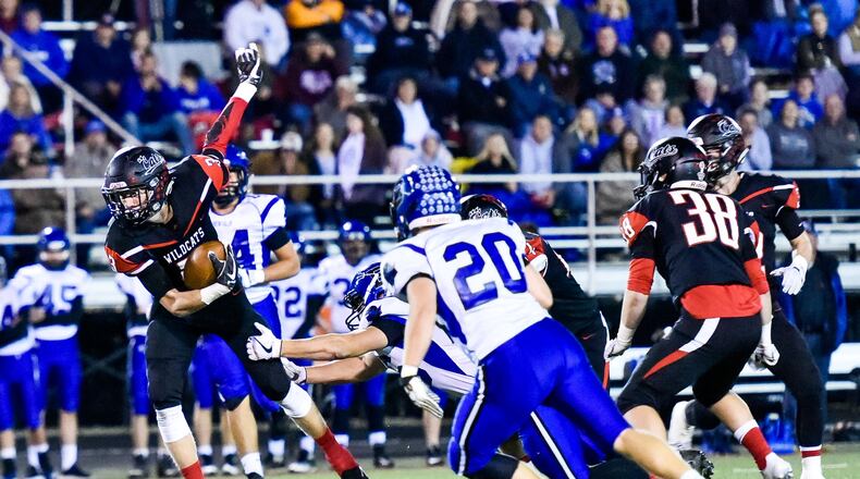 Franklin’s Kyle Rickard returns an interception as Brookville’s Jacob Vore (20) closes in during last Thursday’s 24-21 win for the host Wildcats at Atrium Stadium in Franklin. NICK GRAHAM/STAFF