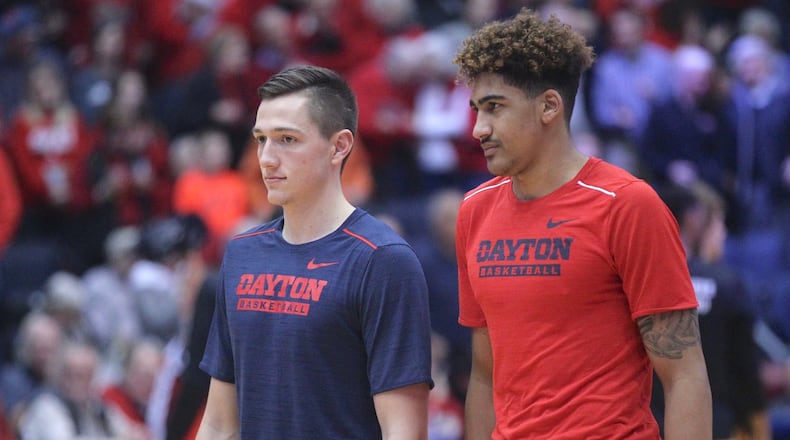 Dayton’s Ryan Mikesell and Obadiah Toppin watch the team warm up before a game against Tennessee Tech on Dec. 6, 2017, at UD Arena. David Jablonski/Staff
