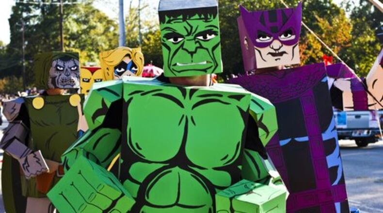 The Incredible Hulk and other Marvel characters follow a comic-themed float during the 10th Annual Little Five Points Halloween Parade in Little 5 Points.