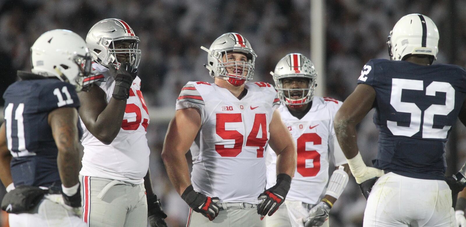 Ohio State’s Isaiah Prince (59), Billy Price (54) and J.T. Barrett (16) line up for a play against Penn State on Saturday, Oct. 22, 2016, at Beaver Stadium in State College, Pa. David Jablonski/Staff