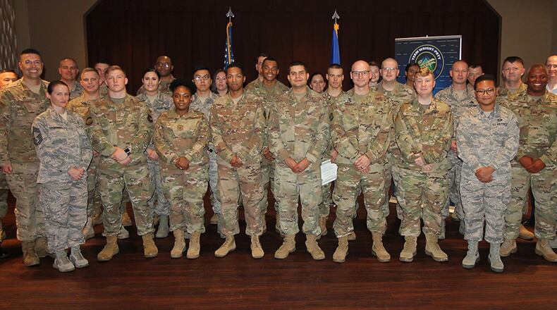 Col. Thomas Sherman (left), 88th Air Base Wing and installation commander, and Chief Master Sgt. Stephen Arbona (right), 88th Air Base Wing command chief, congratulate the newest Team Wright-Patt enlisted promotees during a ceremony at the Wright-Patt Banquet Club, Wright-Patterson Air Force Base, Sept. 30. (U.S. Air Force photo/Thomas Lewis)
