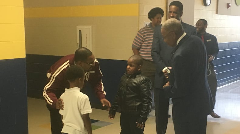 Men of Color volunteer Richard Jones talks to two boys at World of Wonder school at Residence Park on Wednesday, Nov. 2, 2016. The Men of Color program exposes black male students in Dayton schools to community leaders and role models. JEREMY P. KELLEY / STAFF