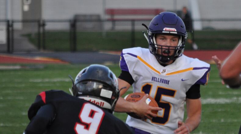 Bellbrook junior quarterback Brendan Labensky looks downfield while Tecumseh’s Blais Hale waits to deliver a hit Thursday Sept. 7, 2017, at Spitzer Stadium Sept. 7, 2017. Nick Dudukovich/Contributed