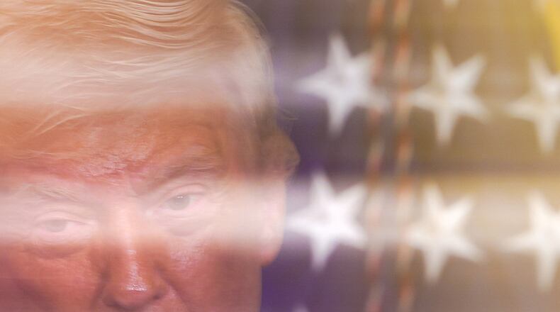 In this image taken with a slow shutter speed, President Donald Trump speaks during a women's history month event in the East Room of the White House, Thursday, March 12, 2026, in Washington. (AP Photo/Julia Demaree Nikhinson)