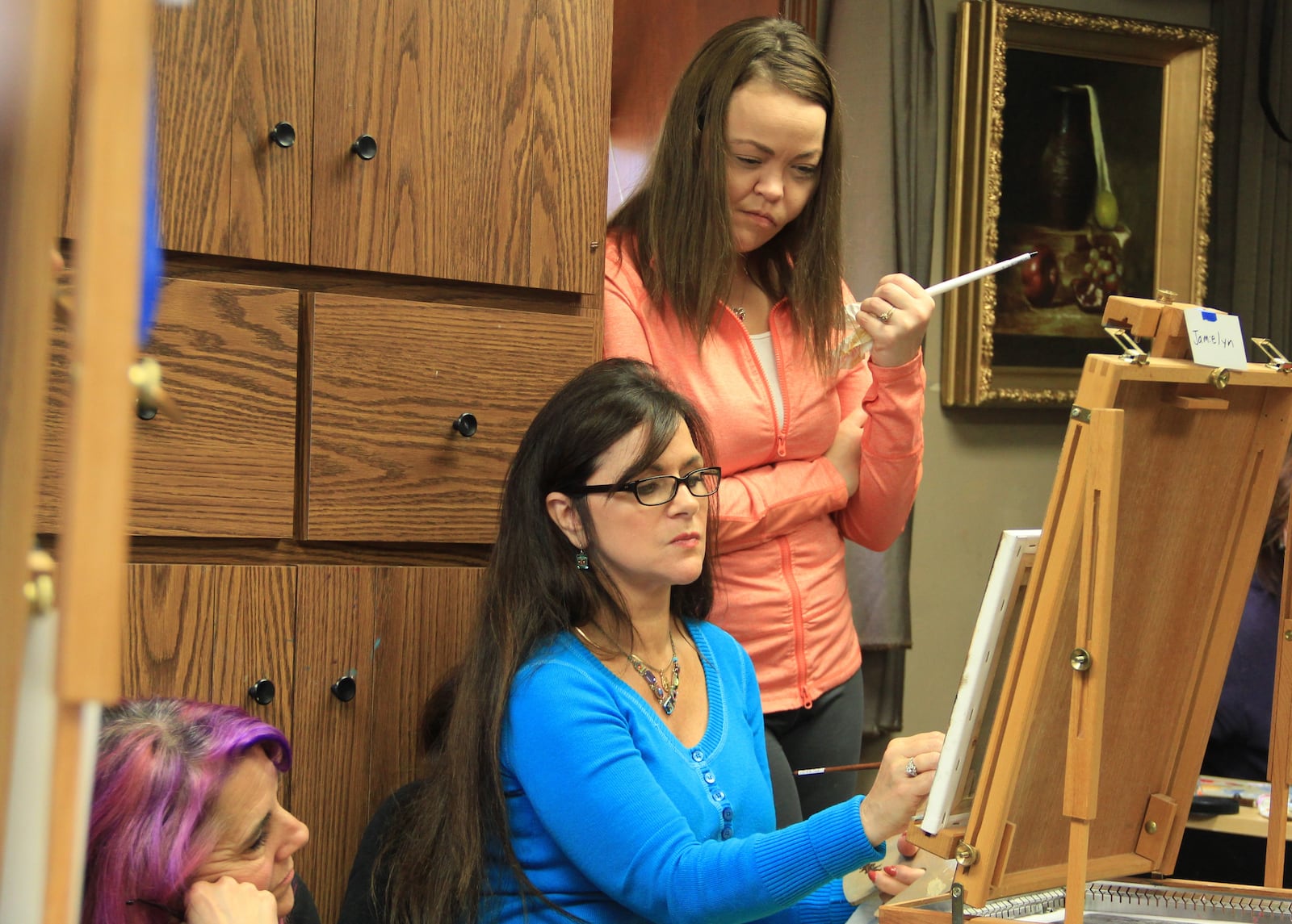 Olde Masters galleria owner Cecilia Brendel works with students at the Centerville galleria.