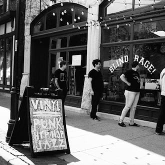 Customers wait outside the current storefront of Blind Rage Records in the Oregon District at 508 E. 5th St., Dayton. JAKE SCHNEIDER/CONTRIBUTED