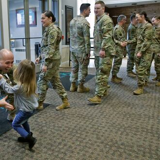 Amelia Bernabei runs into the arms of her father, SSgt. Joey Bernabei, Friday, Jan. 12, 2024 at the conclussion of a Call To Duty Ceremony honoring the Ohio Army National Guard's 1137th Signal Company who are deploying for nine months in Support of U.S. Central Command. About 30 members of the Springfield Company are deploying and participated in the ceremony at The First Christian Church on Middle Urbana Road. BILL LACKEY/STAFF