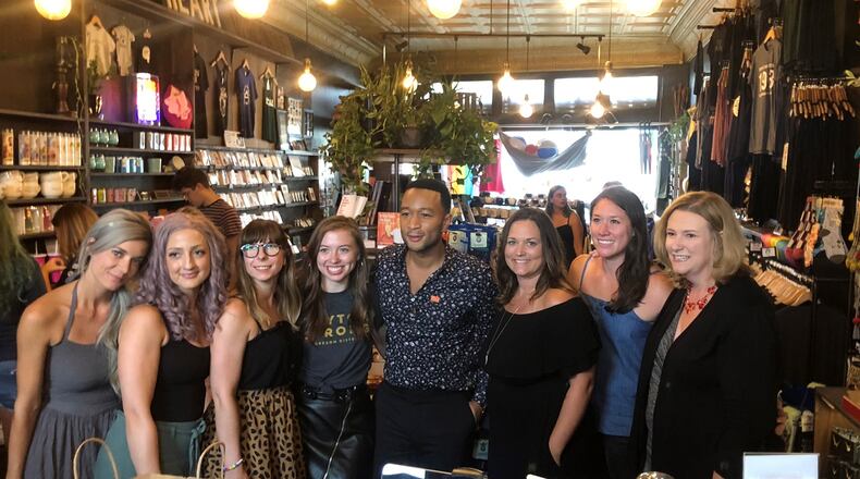 John Legend made a surprise visit to the Oregon District Sunday evening with Dayton Mayor Nan Whaley to show support in the aftermath of the mass shooting Sunday, Aug. 4. He stopped by a number of stores to shop including Heart Mercantile, Brim on Fifth, Puff Apothecary and Beck + Call.  AMELIA ROBINSON / STAFF