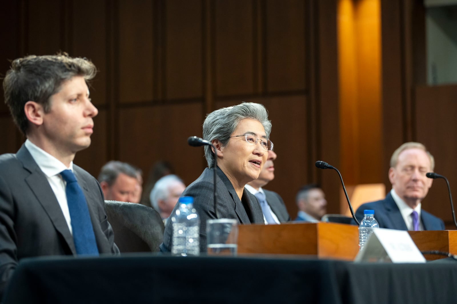 Dr. Lisa Su, chief executive officer and chair, Advanced Micro Devices (AMD), center, testifies before a Senate Committee on Commerce, Science, and Transportation hearing with Sam Altman, co-founder and chief executive officer, OpenAI, left, and Brad Smith, vice chair and president, Microsoft Corporation, right, Thursday, May 8, 2025, in Washington. (AP Photo/Kevin Wolf)