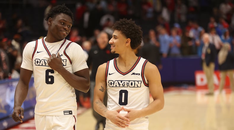 Dayton's Enoch Cheeks and Javon Bennett leave the court after a victory against Grambling State on Saturday, Dec. 2, 2023, at UD Arena. David Jablonski/Staff