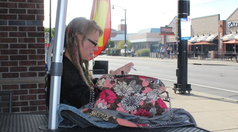 Brandi Morris, 36, of Dayton, smokes a cigarette during her lunch break on Brown Street Thursday Oct. 10, 2019. A state law change goes into effect raising the legal tobacco age from 18 to 21. RICHARD WILSON/STAFF