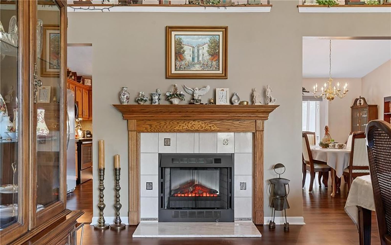 The living room features an electric fireplace and is next to the kitchen and dining rooms. CONTRIBUTED