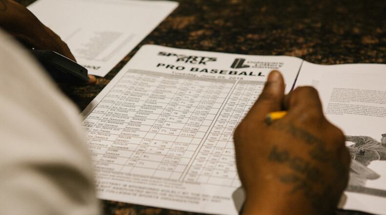 A guest fills out a pick sheet during the launch of full-scale sports betting in Dover, Delaware, on June 5. Bloomberg photo by Michelle Gustafson