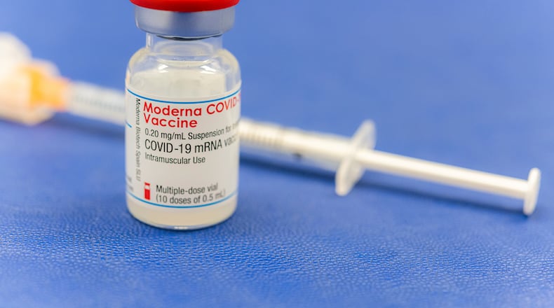An ampoule Moderna vaccine against the COVID-19 disease, stand on the table at the Diakonie Hospital "DIAKO" vaccination ward in Bremen, Germany, Friday, Jan. 15, 2021. Besides the Pfizer/BioNTech vaccine, Moderna is the second corona vaccine approved in the European Union. (Mohssen Assanimoghaddam/dpa via AP)