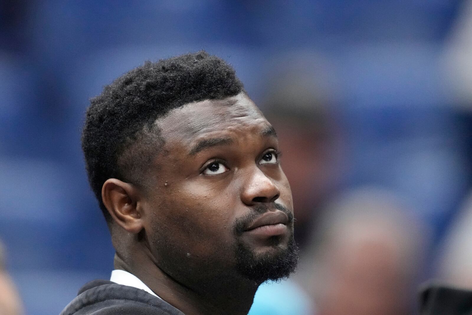 New Orleans Pelicans forward Zion Williamson watches from the bench in street clothes in the first half of an NBA basketball game against the Oklahoma City Thunder in New Orleans, Sunday, April 13, 2025. (AP Photo/Gerald Herbert)