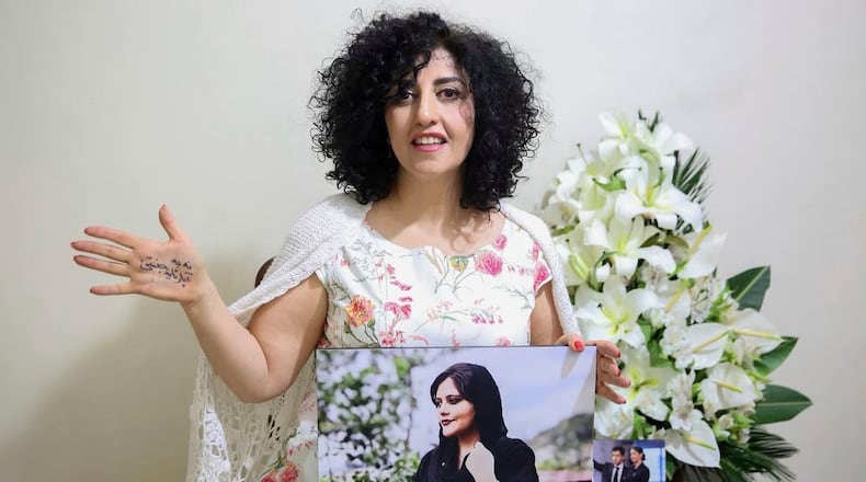 FILE - In this photo released by the Narges Foundation Archive, Nobel Peace Prize laureate Narges Mohammad is seen after being released on a medical furlough in Tehran, Iran, Wednesday, Dec. 4, 2024. On her hand written in Farsi is "End gender apartheid." (Narges Foundation Archive via AP, File)