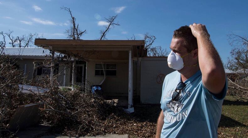 James Filley looks out over the damage to his home on Oct. 17, 2018, at Tyndall Air Force Base, Florida, after returning to the base for the first time since Hurricane Michael struck the base one week before. Support personnel from Tyndall and other bases were on location to support Airmen returning to their homes to assess damage and collect personal belongings.(U.S. Air Force photo/Airman 1st Class Kelly Walker)