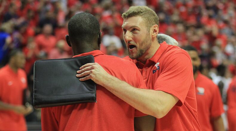Dayton's Anthony Grant greets Sean Damaska as he leaves the court after a victory against Miami on Thursday, Nov. 25, 2021, in the first round of the ESPN Events Invitational at the HP Fieldhouse in Kissimmee, Fla. David Jablonski/Staff