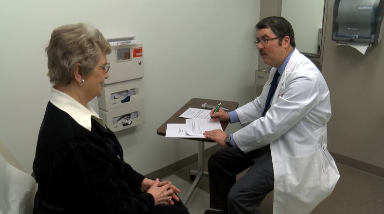 Dr. Douglas Scharre examines Alzheimer’s patient LaVonne Moore. She was part of a pilot study at Ohio State University’s Wexner Medical Center to test how deep brain stimulation may help slow the progression of Alzheimer’s symptoms. PHOTO PROVIDED.