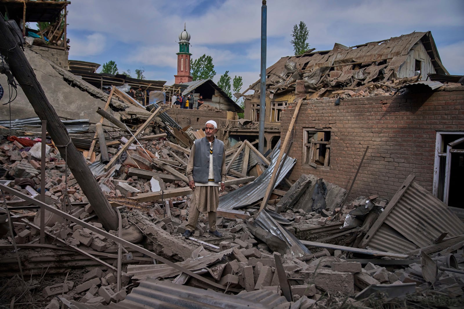 A Kashmiri villager stands amid the debris of the blown-up family home of Ahsan Ul Haq Shiekh, a militant who officials say is involved in the deadly attack on tourists in Pahalgam, at Murran village in Pulwama, south of Srinagar, Indian controlled Kashmir, Saturday, April 26, 2025. (AP Photo/Dar Yasin)