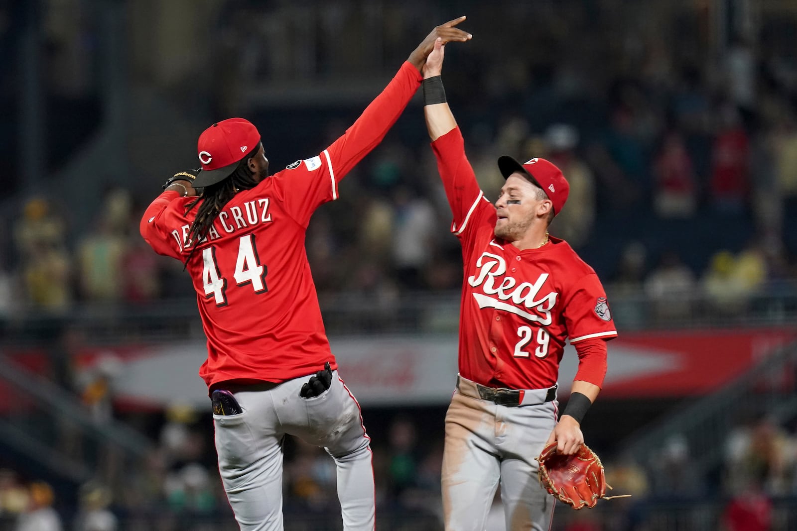Cincinnati Reds shortstop Elly De La Cruz, left, celebrates with center fielder TJ Friedl, right, after defeating the Pittsburgh Pirates in a baseball game Saturday, Aug. 9, 2025, in Pittsburgh. (AP Photo/Matt Freed)