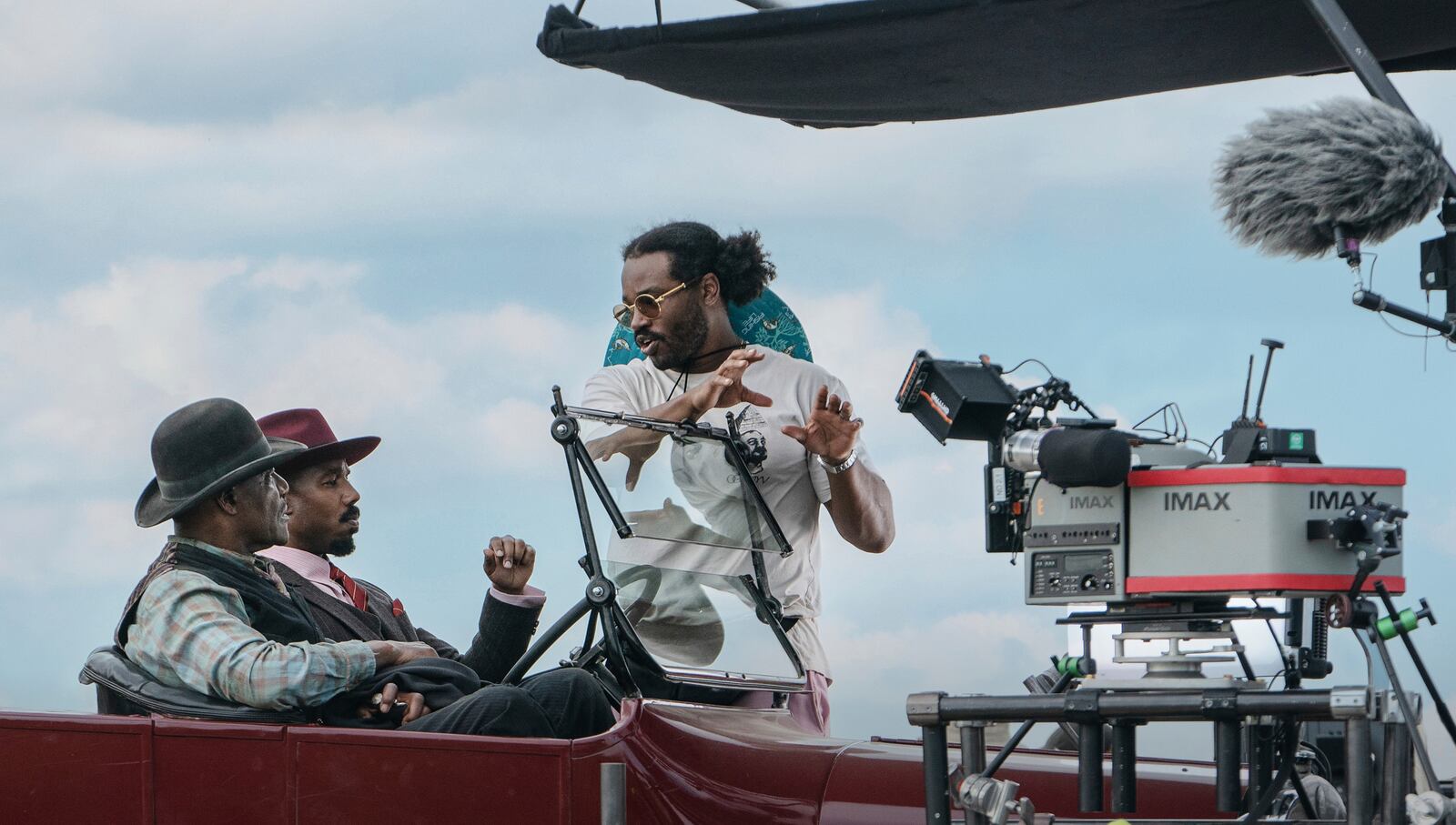 This image released by Warner Bros. Pictures shows actors Delroy Lindo, from left, and Michael B. Jordan with director-writer-producer Ryan Coogler on the set of "Sinners." (Eli Adé/Warner Bros. Pictures via AP)