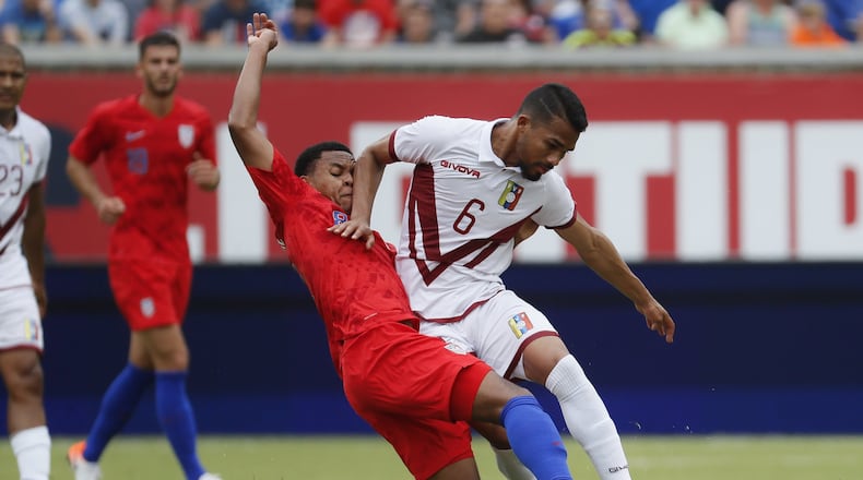 Venezuela midfielder Yangel Herrera (6) and United States midfielder Weston Mckennie (8) vie for the ball during the first half of an international friendly soccer match, Sunday, June 9, 2019, in Cincinnati. (AP Photo/John Minchillo)
