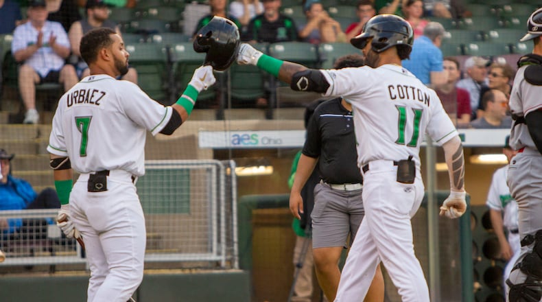 Quin Cotton is greeted at home plate by Francisco Urbaez after hitting his sixth home run to get the Dragons on the scoreboard Wednesday night against Great Lakes. Jeff Gilbert/CONTRIBUTED