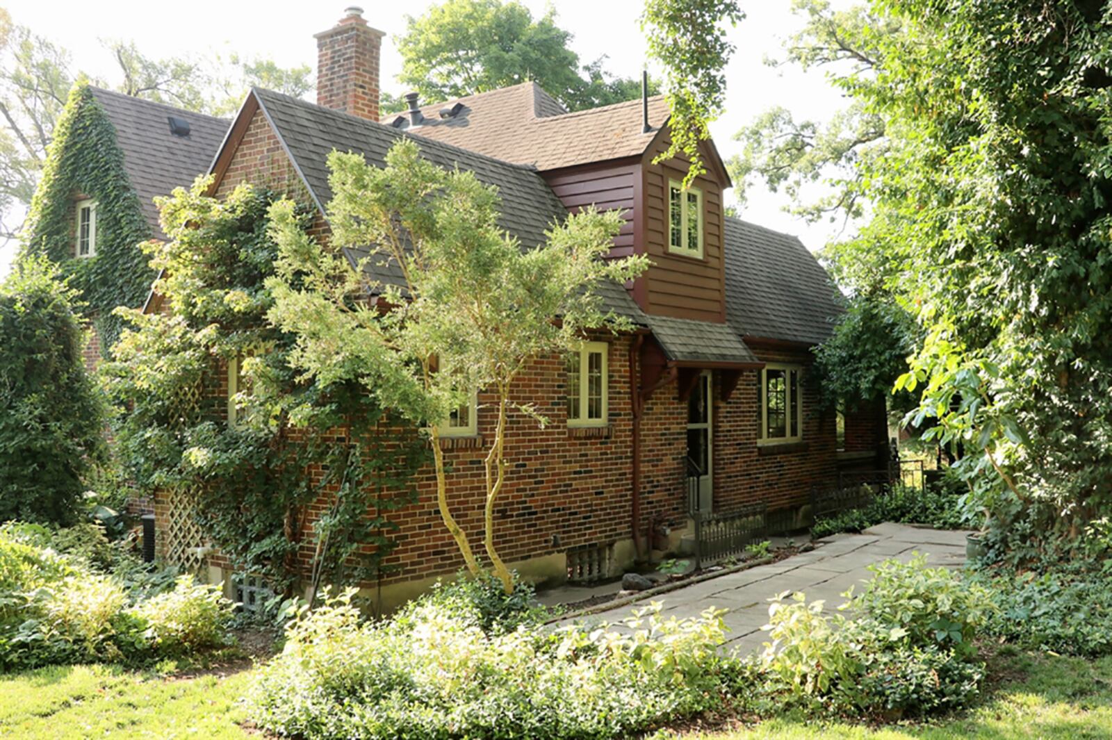 The three-parcel lot has been landscaped into an English garden with flowering garden beds, mature tree islands and shady side patio all within an updated wood privacy fence and wrought-iron gate. CONTRIBUTED PHOTO BY KATHY TYLER